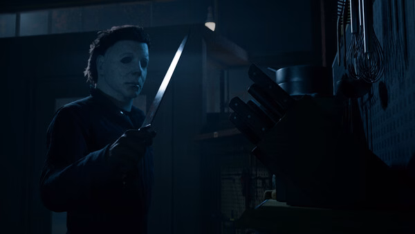 Screenshot from Halloween: The Game showing a masked character holding a knife in a dimly lit kitchen with a knife block nearby.