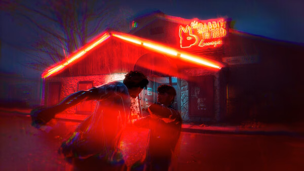 Screenshot from "Halloween: The Game," showing two characters fighting outside a neon-lit building at night.