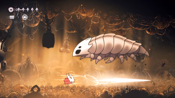 Screenshot of Hollow Knight: Silksong showing a character battling a large, armored insect in a dimly lit cavern.