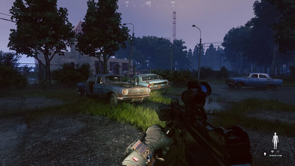 Screenshot from the game Active Matter showing a first-person view of a weapon aimed at abandoned cars in a grassy area at dusk.