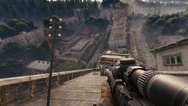 Screenshot from the game Active Matter showing a sniper aiming down a steep urban hillside with dense trees in the background.