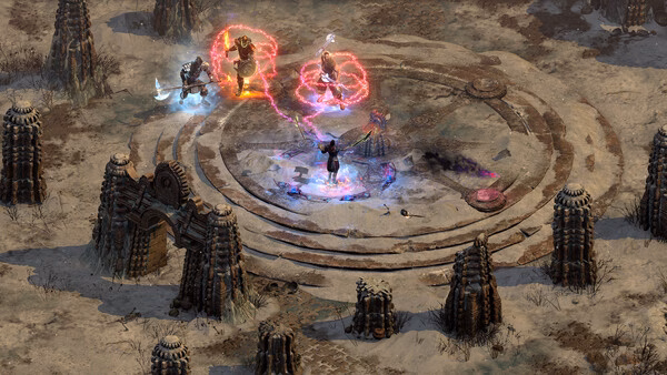 Diablo II: Resurrected screenshot showing four characters battling in a circular arena surrounded by stone structures.