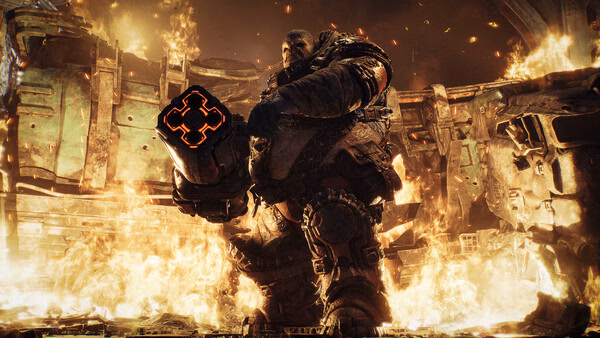 Screenshot from Gears of War: E-Day showing a soldier in heavy armor wielding a glowing weapon amidst raging flames and debris.