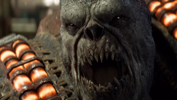 A close-up screenshot from Gears of War: E-Day showing a snarling Locust enemy with sharp teeth and glowing armor plates.
