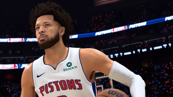 Screenshot from NBA 2K27 showing a basketball player in a Pistons jersey holding a ball on a brightly lit court.